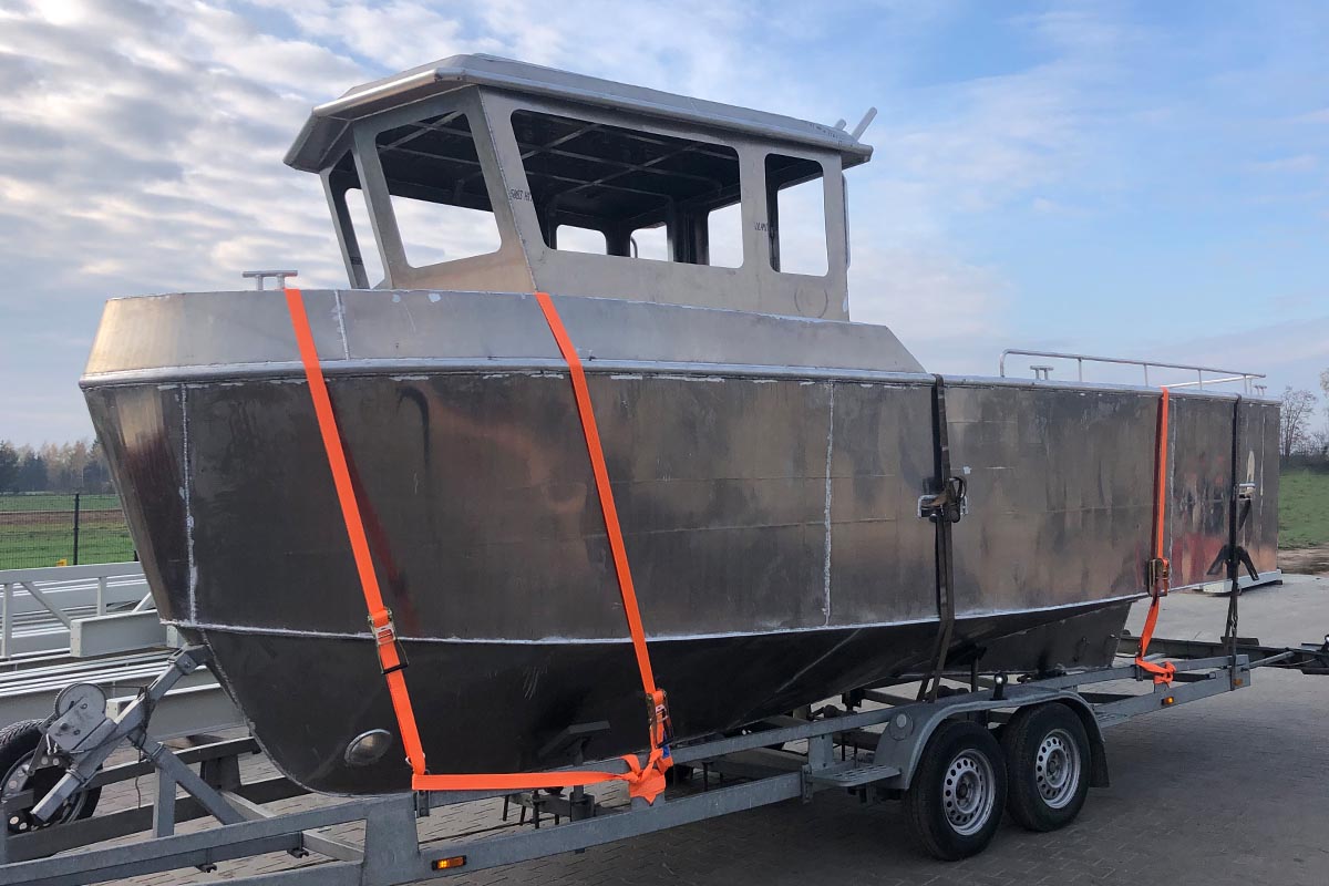 tch marine fishing boat on the lorry